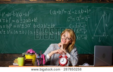 Take Your Time. Teacher With Alarm Clock At Blackboard. Time. Study And Education. Modern School. Kn
