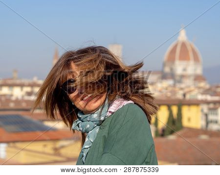 Mature And Beautiful Woman Poses On A Terrace And In Front Of The Florentine Cathedral, Santa Maria 