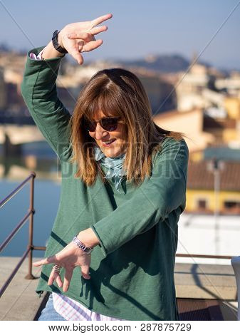 Mature And Beautiful Woman Poses On A Terrace And In Front Of The Florentine Cathedral, Santa Maria 