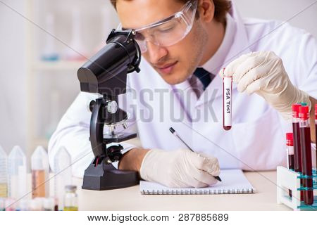 Young handsome lab assistant testing blood samples in hospital 