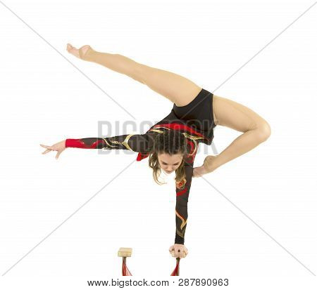Flexible Equilibrist Performs Exercises On Acrobatic Walking Sticks.