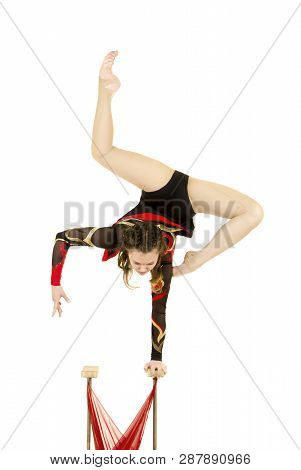 Flexible Equilibrist Performs Exercises On Acrobatic Walking Sticks.