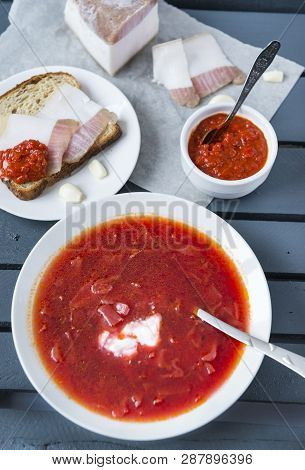 Plate With Borscht With Sour Cream, Borscht With Lard, Bread With Lard Garlic And Ketchup On With Gr