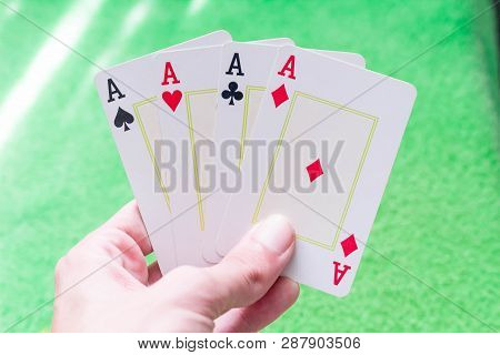 All Aces In Hand With Green Table Background