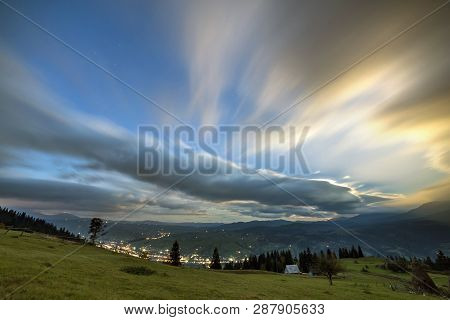 Summer Night Mountain Panorama. Green Grassy Mountain Clearing, Spruce Trees On Blue Evening Sky Cop