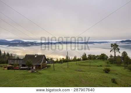 Summer Mountain Panorama. Small Wooden House Cottage And Barn On Green Mountain Valley On Bright Fog