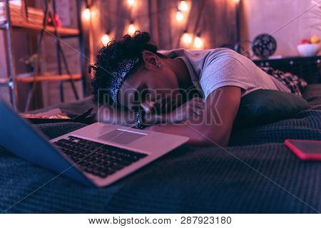 Teenager Tired Of Having Fun All Day And Falling Asleep Right Next To Laptop.