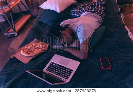 Guy Was Tired So He Didnt Even Eating Pizza And Falling Asleep With His Smartphone And Laptop.