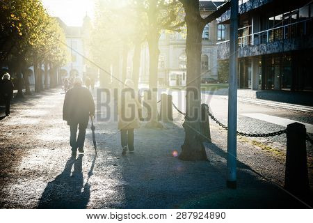 Karlsruhe, Germany - Oct 29 2017: Rear View Of Adults And Seniors Walking On Alley Schloss Bezirk Ne