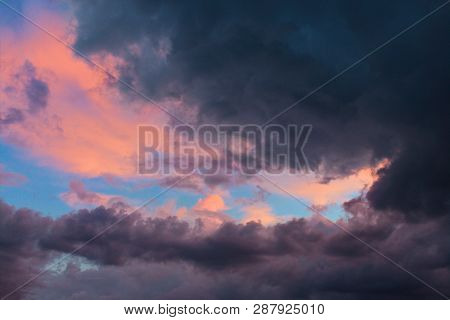 Sunset  With Black Clouds At A Stormy Day