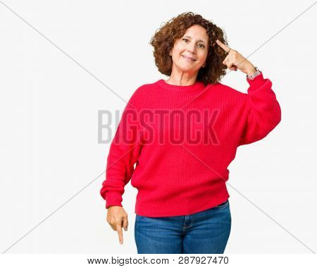 Beautiful middle ager senior woman red winter sweater over isolated background Smiling pointing to head with one finger, great idea or thought, good memory
