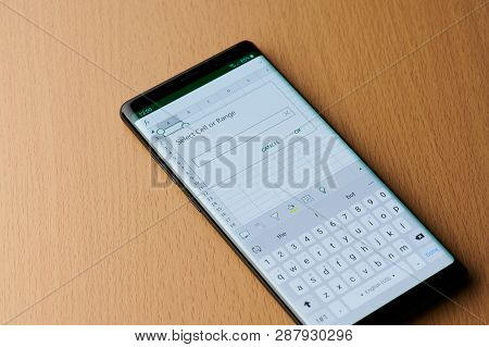 New York, Usa - March 6, 2019: Microsoft Excel Application On Smartphone Screen Laying On Wooden Des