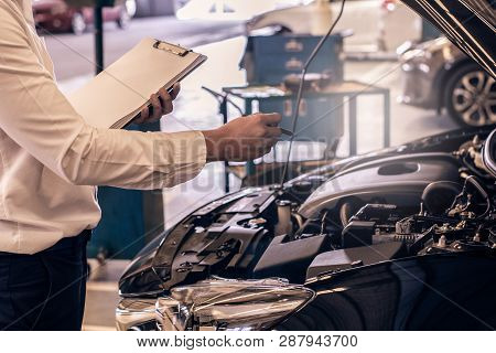 This Career Man Saleman Business Inspection Writing Note On Notepad Or Book, Paper With Car Blurry B