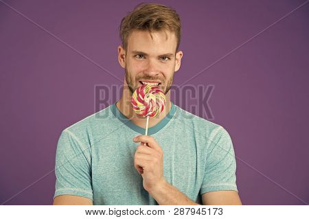 Who Cares About Diet. Man Bites Big Sweet Lollipop. Man With Bristle Likes Sweets. Spoiled Diet. Spo