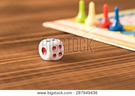 Multi-colored Game Chips With Dice On The Playing Board. Board Game Concept