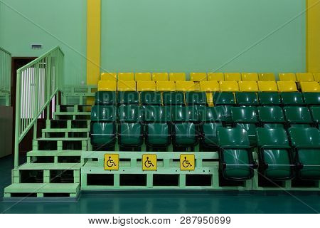 Green And Yellow Seats And Seats For The Disabled. Seating Seats Sports Hall. Copy Space. Territory 