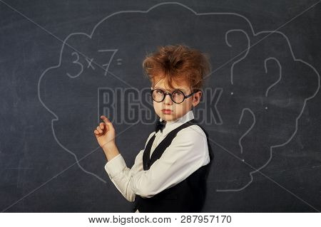 Brooding Boy Elementary School Student At The Blackboard