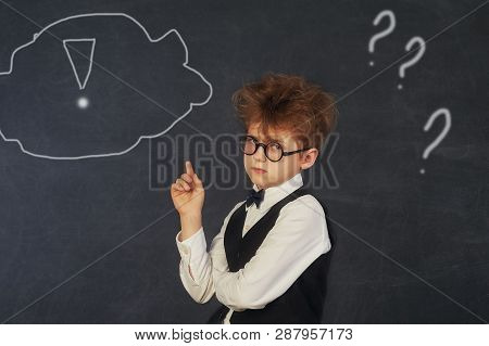 Brooding Boy Elementary School Student At The Blackboard