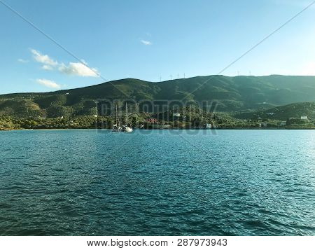 View From The Yacht To The Island With The Traditional Architecture In The Greek Style