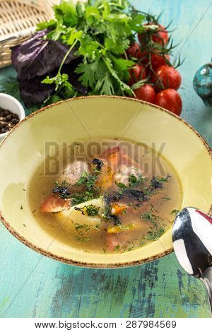Soup With Meat Balls And Vegetables On Blue Wooden Table