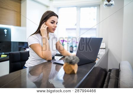 Smiling Woman Casualy Dressed Listen Music Wearing Earphones Using Laptop Computer While Sitting On