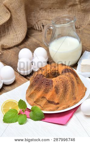 Homemade Lemon Bundt Cake With Lemon, Melissa, Milk, Eggs And Tea