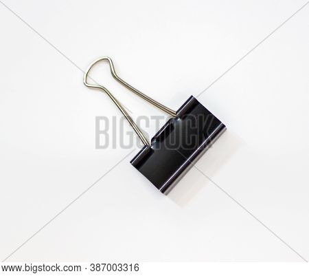 Clip For Papers. Binding Of Papers, Office Supplies. Binder For Papers On A White Background