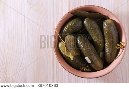 Pickled Cucumbers In A Bowl On A Wooden Surface. Close-up. Place For Text.