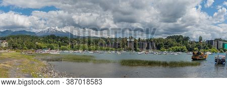 Pucon, Chile-january 31, 2020: Boats On The Shore Of Lake Villarrica With The Volcano Of The Same Na