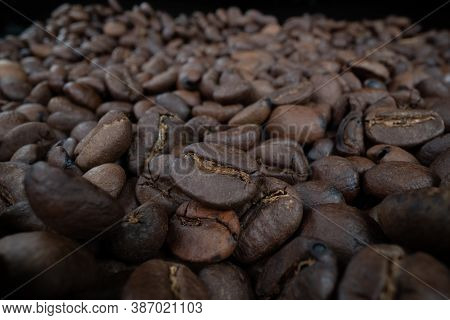 Close Up Of Coffee Beans Spred Across Table Surface