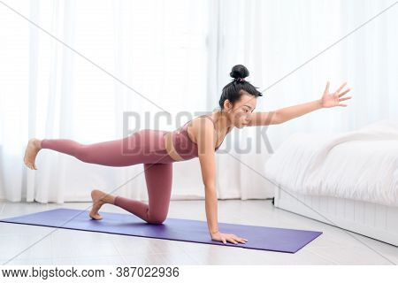 Young Woman Do Yoga In A Bed Room