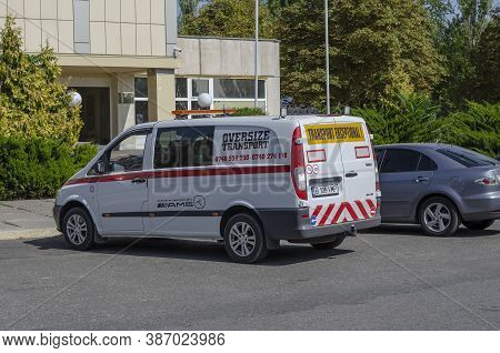 Nikolaev, Ukraine - September 19, 2020: Pilot Vehicle Escorting Oversize Transports In The Parking L