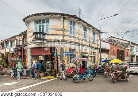 George Town, Penang, Malaysia - December 1, 2019: Street Life With Classic Local Rickshaw In George 