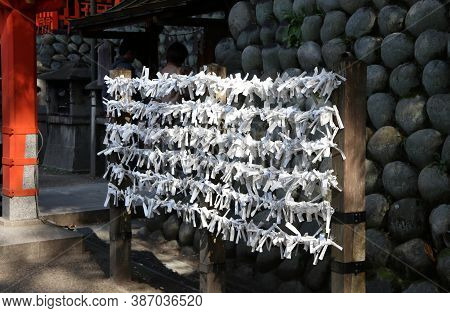 Fushimi-ku, Kyoto, Japan, November 17, 2017 : Bad Luck Of White Predict Fortune Paper Tied Together 