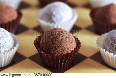 Energy Balls On A Chessboard. Sweets Proper Nutrition. Made From Dates, Oatmeal, Peanuts, Coconut.