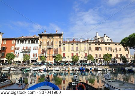 Desenzano, Italy - October 8:  The View Across Boats Moored In The Resort Town Of Desenzano To Cafes