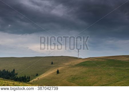 4 G Antenna On The Top Of A Mountain, Dramatic Storm Clouds In The Background.
