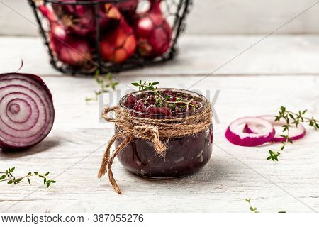 Red Onion Marmalade Jam Confiture In Jar. Vegetable Jam On White Wooden Background. Delicious Sauce.