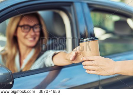 But First Coffee. Happy Caucasian Businesswoman Sitting Behind Steering Wheel Of Her Modern Car And 