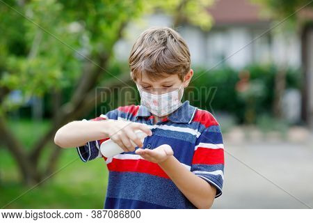 School Kid Boy With Medical Mask As Protection Against Pandemic Coronavirus Quarantine Disease. Chil