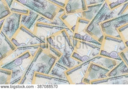 100 Nepalese Rupees Bills Lies In Big Pile. Rich Life Conceptual Background