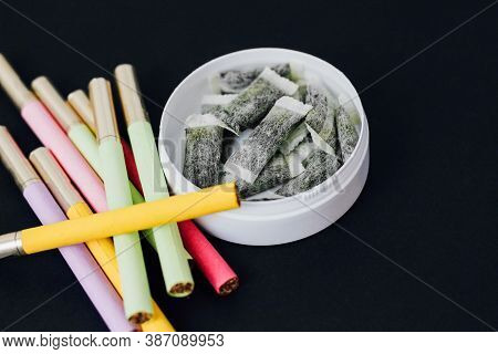 Round Box Of Snus With Multicolored Cigarettes Cigarette Substitute, Nicotine Pouches.