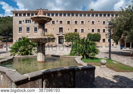 Ancient Stone Fountain Surrounded By Nature, Located At The Entrance Of The Monastery Of Lluc, Islan