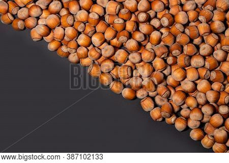 Hazelnuts. Stack Of Hazelnuts. Food Background. Hazelnut On Darck Background.