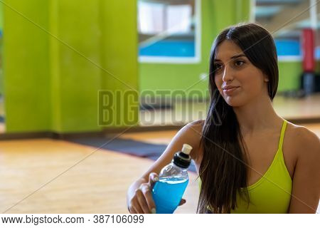 Girl Resting And Getting Ready For A Session Of Sport With Energetic Drink By Her