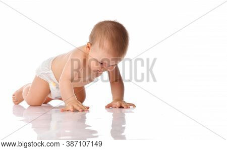 Young Baby Explorer In Diaper Crawling On Studio Floor Isolated On White Background. Little Toddler 