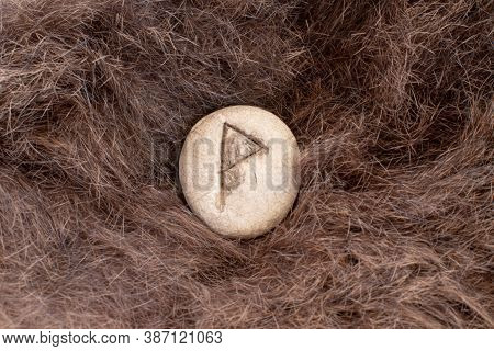 Wunjo Nordic Stone Rune On Animal Fur. Letter Wyn Of The Viking Alphabet.