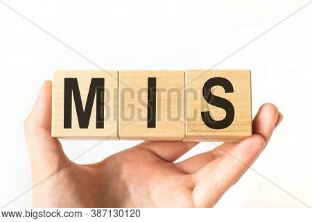Hand Holds Wooden Cubes With Letters Mis. Business Concept Image.