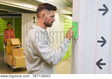 Side View At Bearded Man Using Touch Pad With Green Screen While Operating Self Storage Unit, Copy S