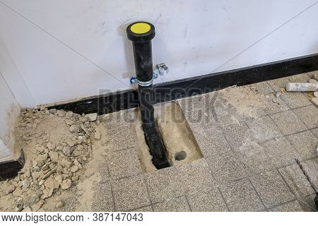A Black Polypropylene Drain Pipe Worked Into The Floor